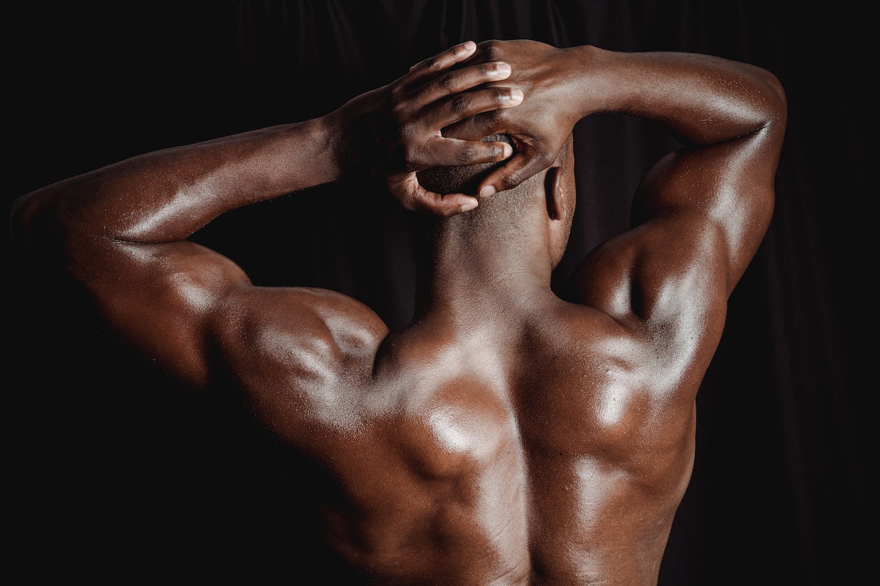 A Shirtless Man Flexing His Muscle