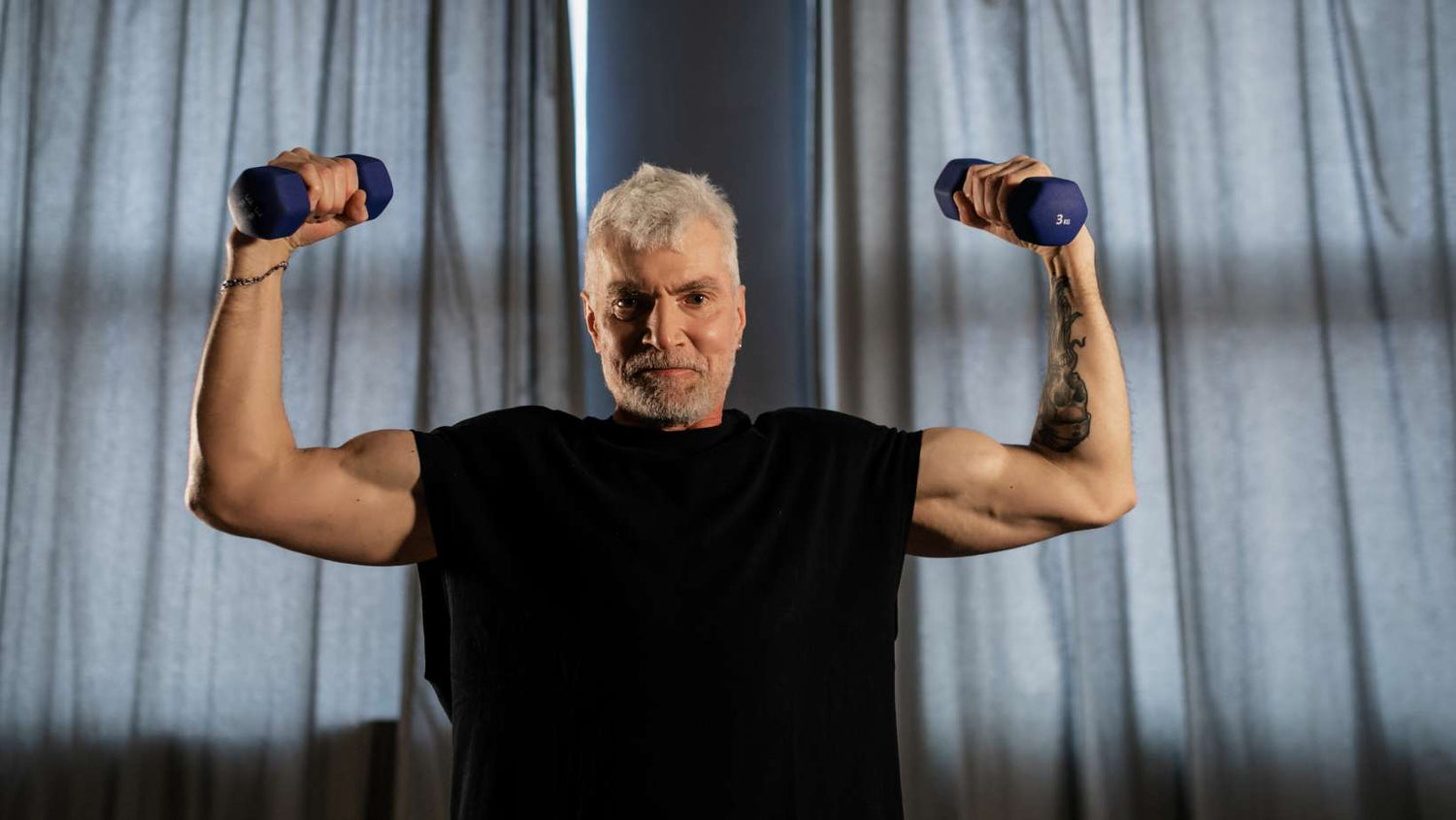 An Elderly Man Lifting Dumbbells