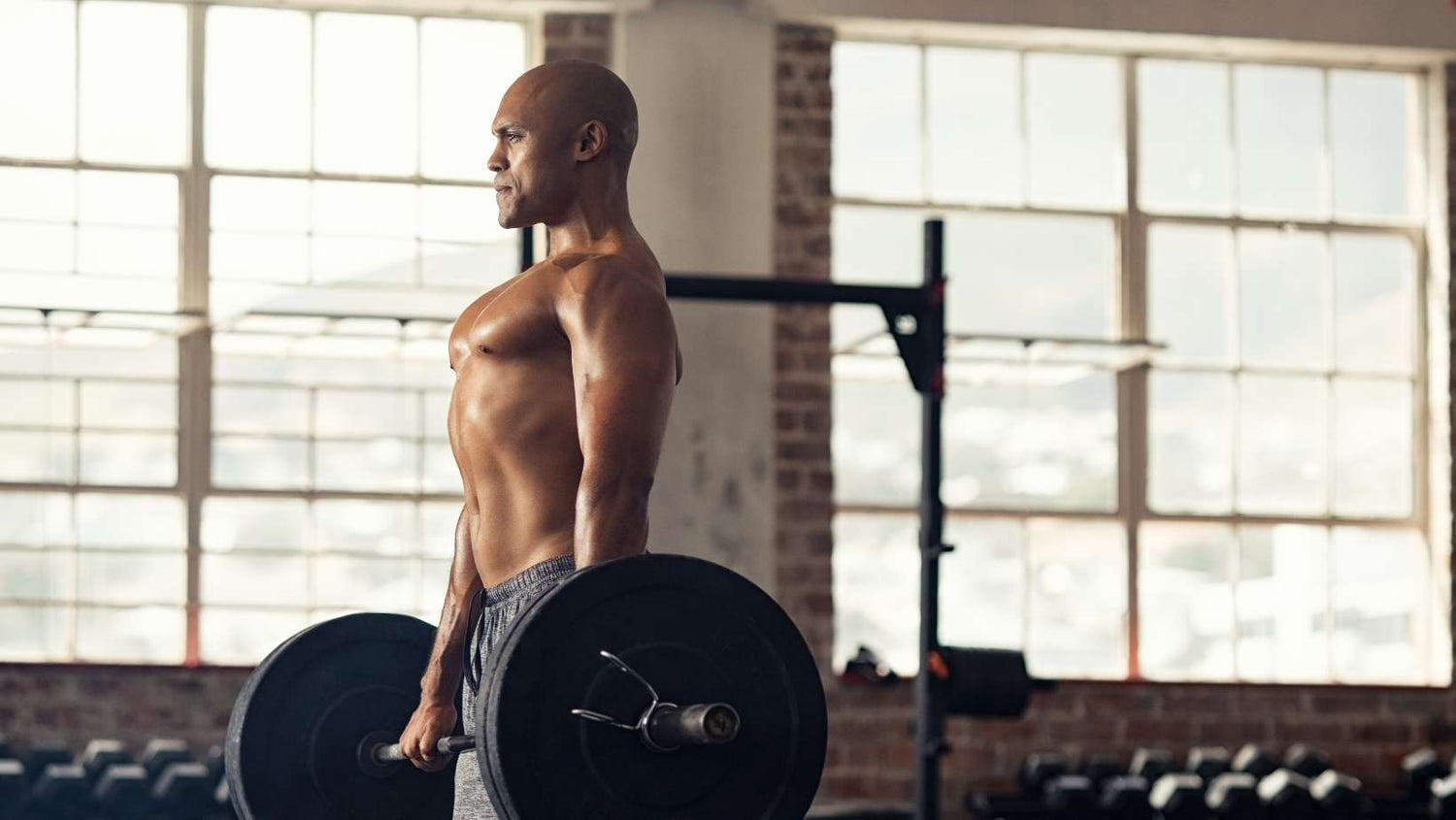 Man Holding Heavy Barbell at the Gym