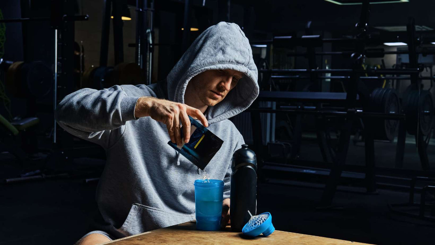 Man Pouring Creatine Supplement in Bottle