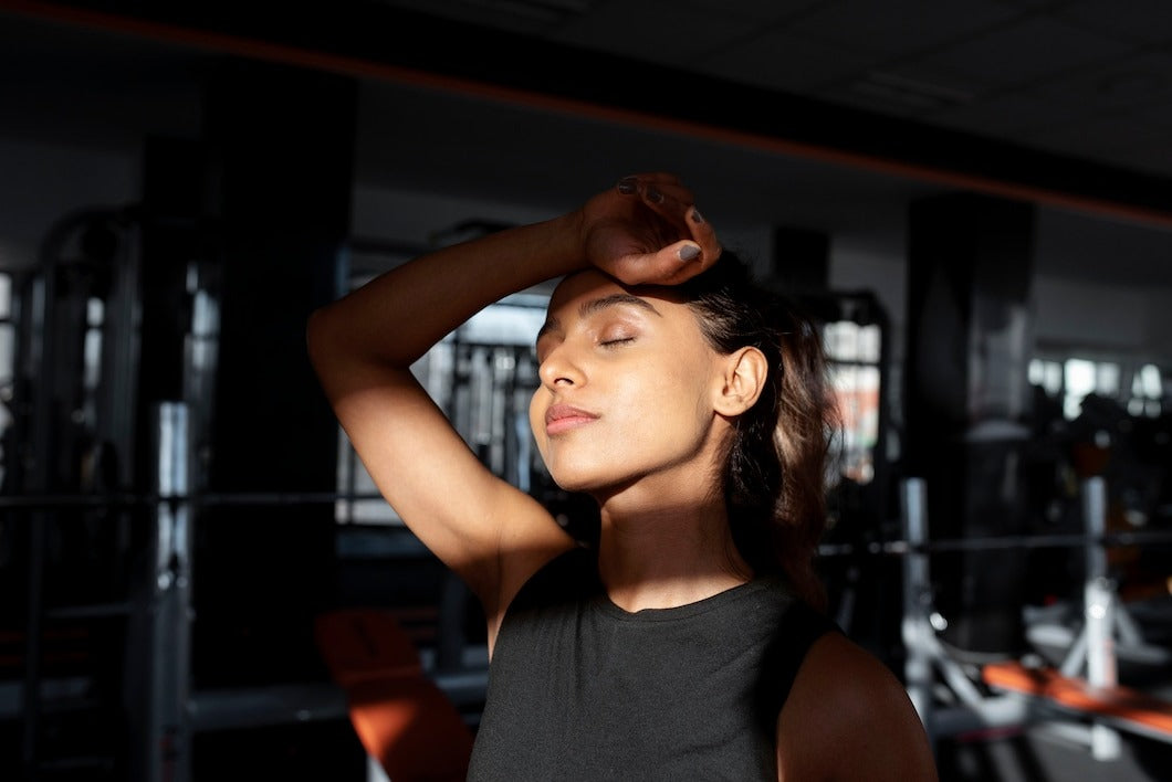 Medium shot tired woman at gym