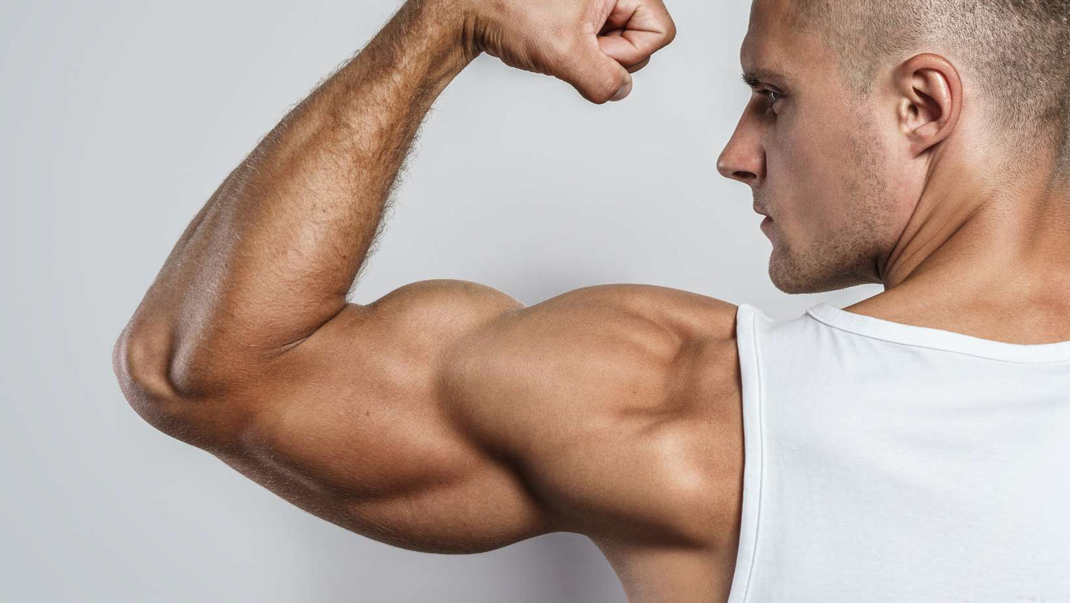 Young Bodybuilder Man Showing His Muscular Arm