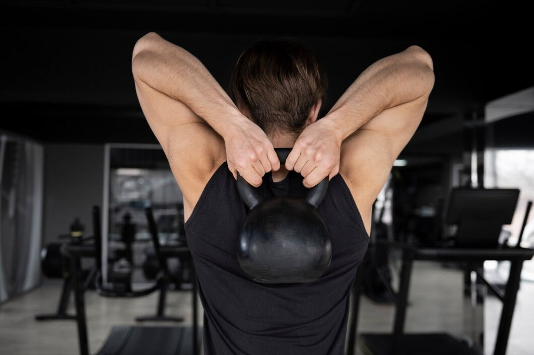 man training with kettlebells